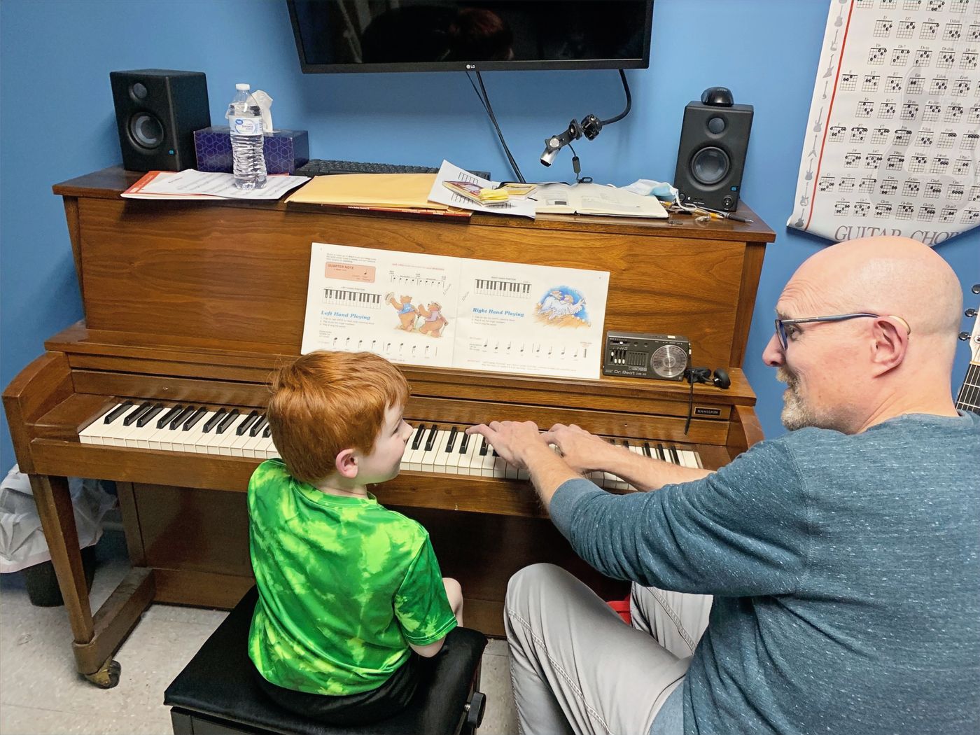 Chris teaching a young student at the piano