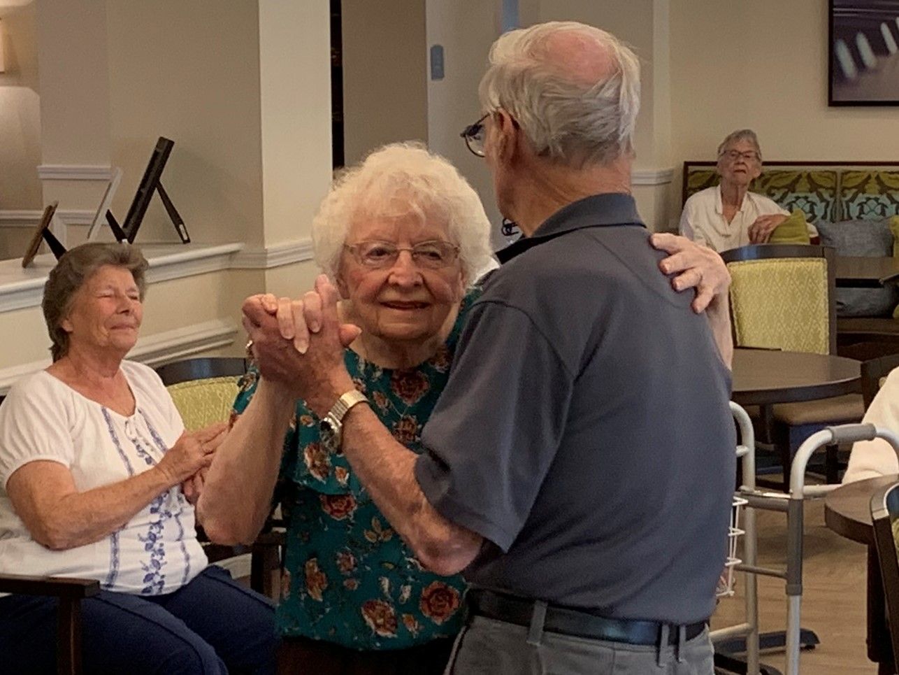 Senior residents dancing together during a sing-along